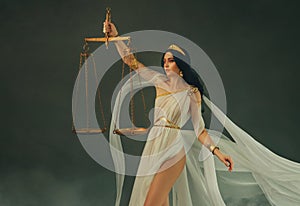 Portrait fantasy woman Greek goddess of justice Themis holding golden scales in hands. White silk vintage dress old