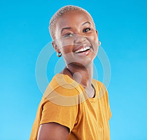 Portrait, fashion and funny black woman in studio isolated on a blue background. Face, happy and young African person