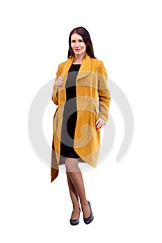 Portrait of fashion girl in yellow coat posing