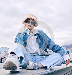 Portrait, fashion and Islamic woman in a city, sunglasses and trendy with a hijab, stylish outfit or gen z. Face, Muslim