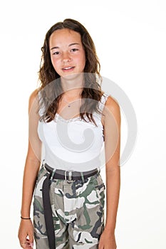 Portrait of fashion lovely young woman with dark curly hair posing with kind smile in army pant shirt isolated over white