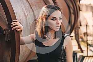 Portrait of Fashion Model Girl on the Industrial Background.