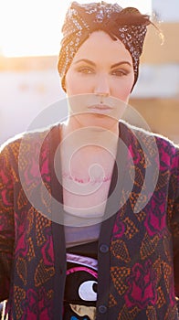 Portrait, fashion and serious woman in city with scarf on head, urban tattoo and stylish. Face, street and trendy female