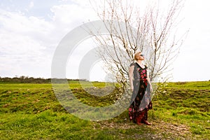 Portrait of fashionable blonde woman posing outside