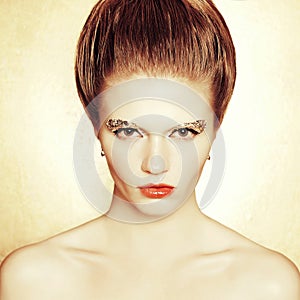 Portrait of fashionable model with retro hairdo, arty make-up