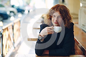 Portrait fashionable reddish man drinking coffee