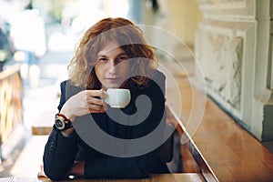 Portrait fashionable reddish man drinking coffee