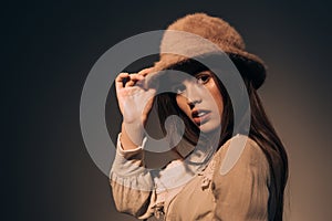 portrait of fashionable woman in hat looking away