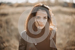 portrait of a fashionable young Caucasian brunette girl in a leather jacket