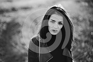 portrait of a fashionable young Caucasian brunette girl in a leather jacket