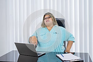 Portrait of fat businesswoman daydreaming happily