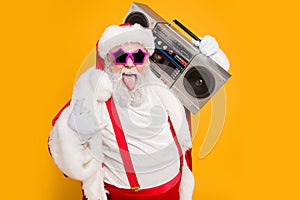 Portrait of fat white hair funny santa claus heavy metal x-mas hipster party hard on noel celebration show horns sign