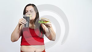 Portrait of fat woman rejects high calorie food while closed her mouth.Diet.