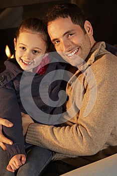 Portrait father and daughter by firelight