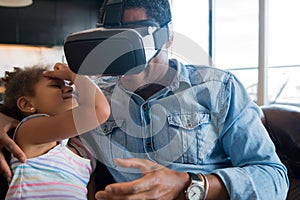 Father and daughter playing video games. photo