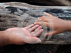 Portrait Of Father Hand Reaching For Child Hand Is To Helps