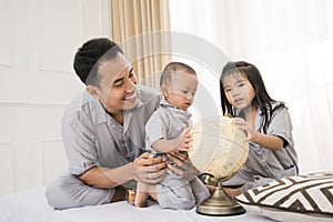 Portrait of a father playing with his children