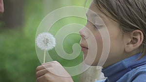 Portrait of a father and son with a flower dandelion. The bearded father playing with his son.