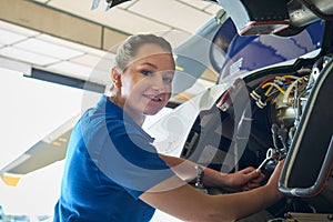 Portrait Of Female Aero Engineer Working On Helicopter In Hangar photo