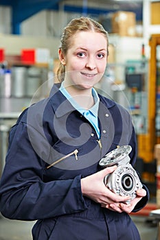 Portrait Of Female Apprentice Holding Component