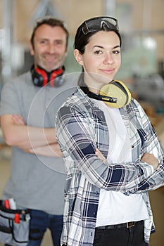 portrait female apprentice and supervisor in workshop