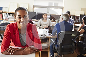 Portrait Of Female Architect With Meeting In Background