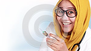 Muslim Female Doctor Holding Injection Syringe