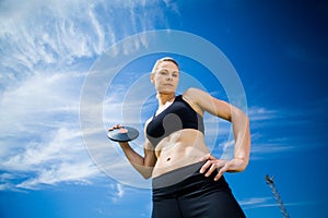 Portrait of female athlete holding a discus