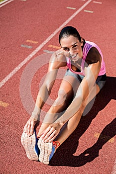 Portrait of female athlete stretching her hamstring