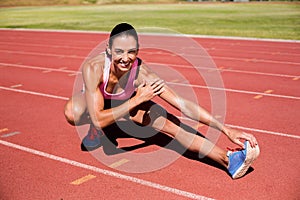 Portrait of female athlete stretching her hamstring