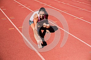 Portrait of female athlete stretching her hamstring