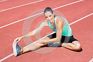 Portrait of female athlete stretching her hamstring