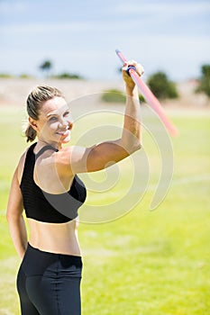 Portrait of female athlete about to throw a javelin