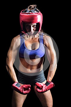 Portrait of female boxer flexing muscles