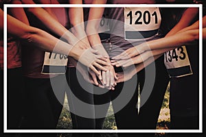 Female breast cancer marathon runners stacking hands