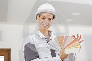 portrait female builder holding colour samples