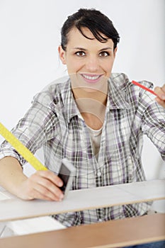 portrait female carpenter standing with work tool