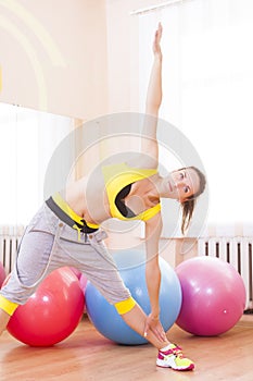 Portrait of Female Caucasian Athlete In Good Fit Having Body Shape and Stretching Exercises