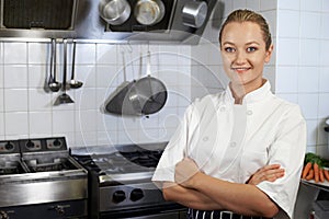 Portrait Of Female Chef Standing In Kitchen