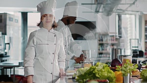 Portrait of female chef with uniform working in restaurant kitchen