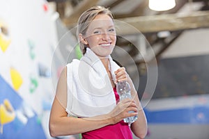 Portrait female climber holding bottle water