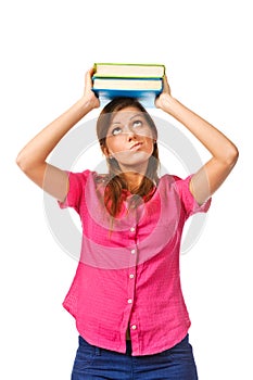 Portrait of female college student carrying a pile of books over