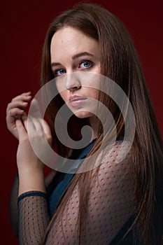 Portrait of a female in a colored dress on red background