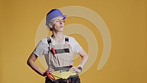 Portrait of female construction worker being dizzy and seeing cartoonish stars