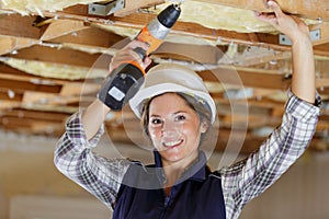 portrait female construction worker using drill