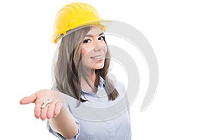 Portrait of female constructor handing door key photo