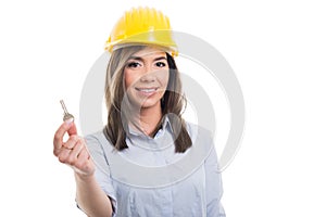 Portrait of female constructor showing one key photo