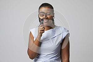 Portrait Of Female Criminologist With Magnifying Glass photo