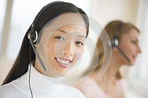 Portrait Of Female Customer Service Representative Smiling At Of