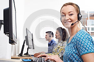 Portrait Of Female Customer Services Agent In Call Centre